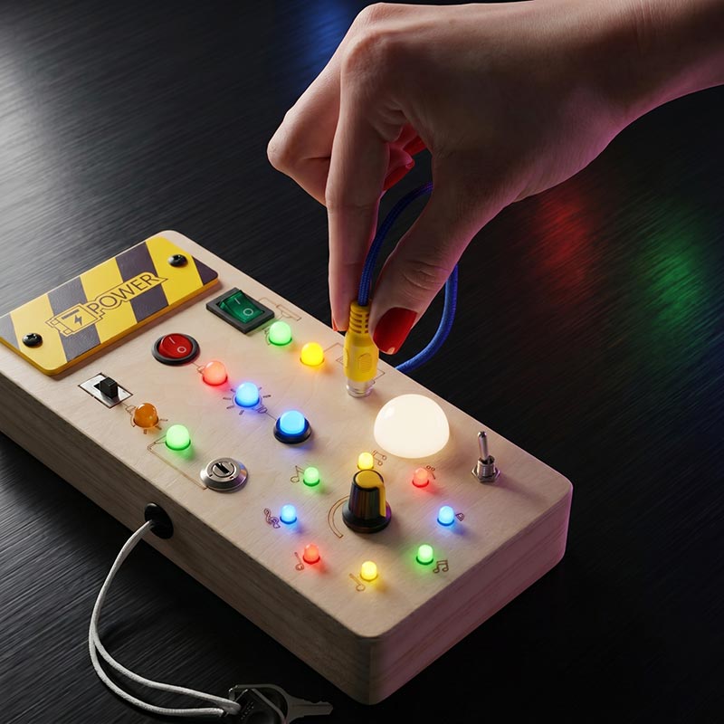 Tableau d'activités en bois à interrupteurs lumineux