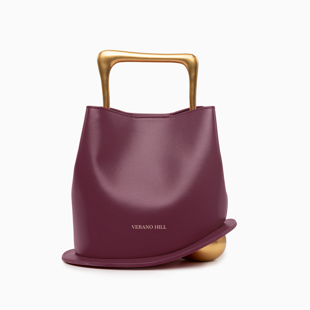 Sac à main en cuir à base arrondie, anse géométrique