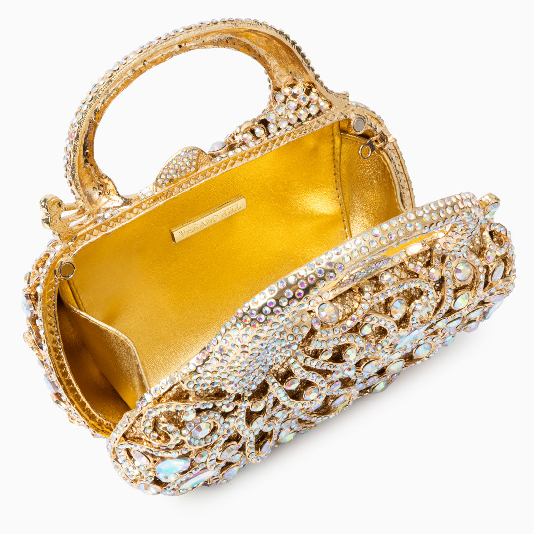 Sac à main doré à strass et motif de volutes